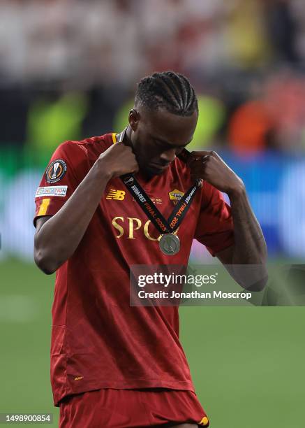 Tammy Abraham of AS Roma removes his medal as he walks past the trophy after collecting his Runners' Up Medal following the penalty shoot out defeat...