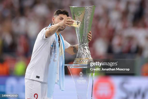 Gonzalo Montiel of Sevilla takes a selfie the trophy using his Argentina FIFA World Cup Commemorative gold iphone given to the team by Leo Messi,...