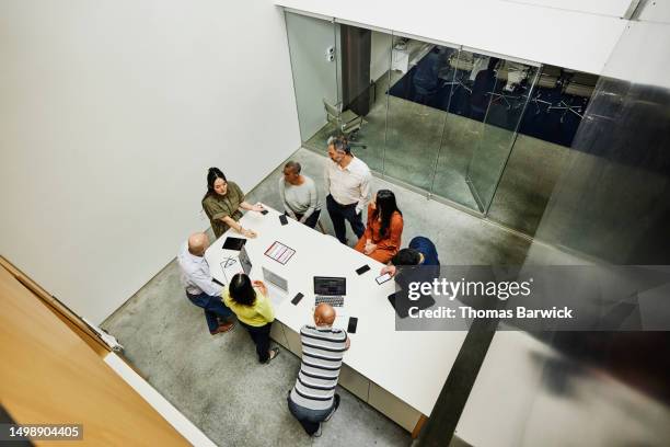 wide high angle shot businesswoman leading project meeting in office - top view stock pictures, royalty-free photos & images