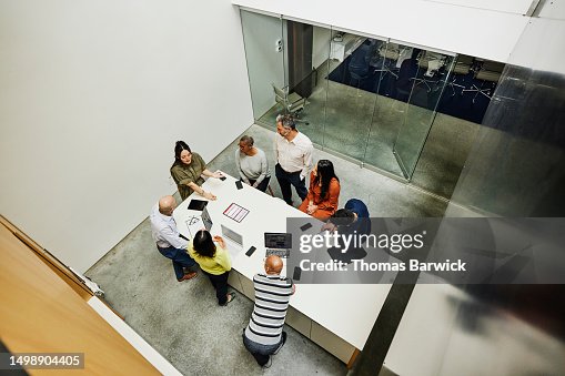 Wide high angle shot businesswoman leading project meeting in office Wide high angle shot businesswoman leading project meeting in office