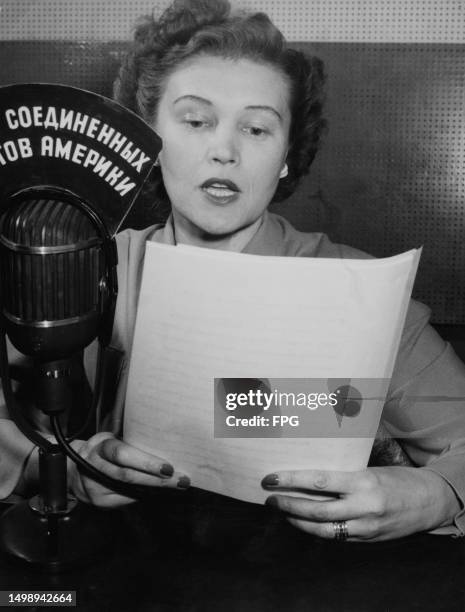 American broadcaster Tatiana Hecker, the sign on her microphone written in Russian, as Voice of America broadcasts to the Soviet Union from the State...