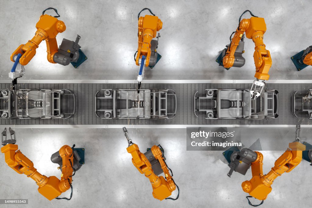 Industrial Robots At The Automatic Car Manufacturing Factory Assembly Line