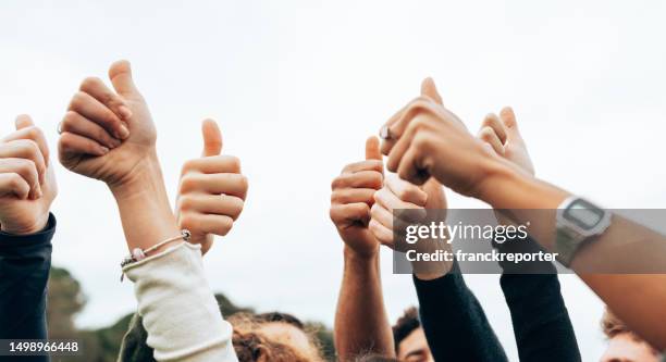 thumbs up of friends all together - representing stock pictures, royalty-free photos & images
