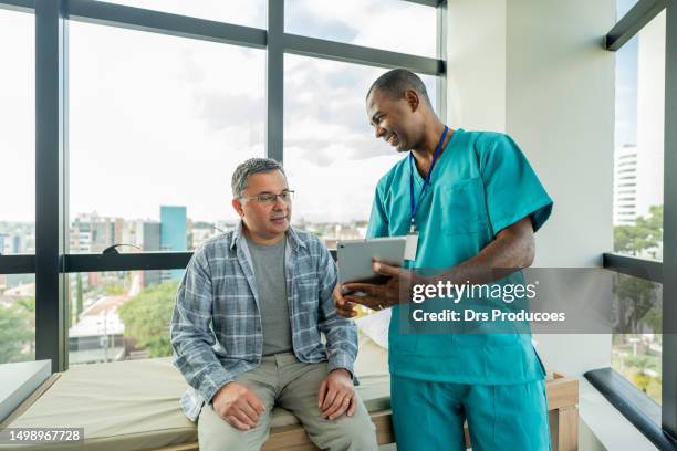 mature man in medical consultation - patient safety stock pictures, royalty-free photos & images