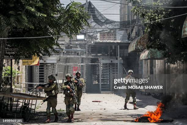 Israeli soldiers walk before a checkpoint during clashes in the centre of Hebron in the occupied West Bank on July 4, 2023. Israel's biggest military...