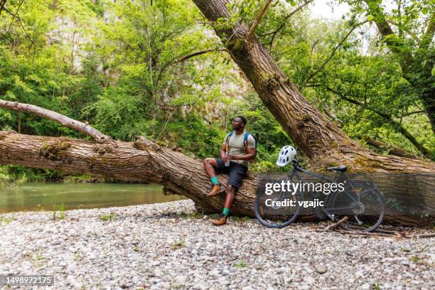 young black man with bike enjoying nature - nature reserve stock pictures, royalty-free photos & images