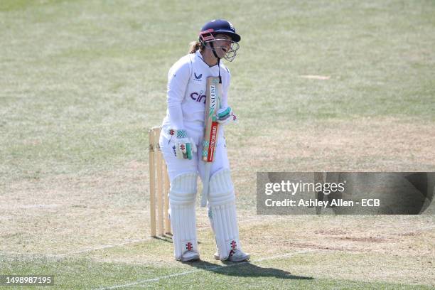 Tammy Beaumont of England Women laughs after accidentally dropping her bat as the bowler was running in during the tour match between England Women...