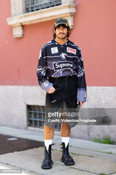 Guest is seen wearing a Supreme sports shirt, baseball cap and a slit denim skirt outside Valentino show during the Milan Fashion Week - Menswear...