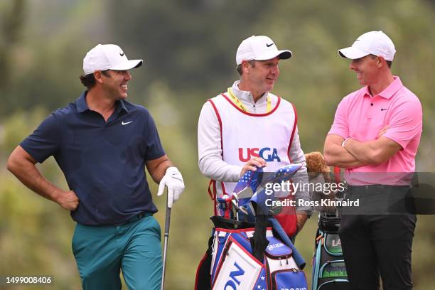 Rory McIlroy of Northern Ireland shares a laugh with Brooks Koepka of the United States on the 13th hole during the second round of the 123rd U.S....