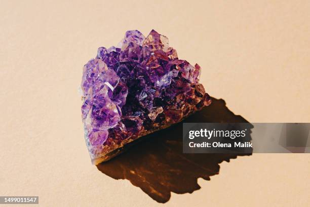 close up of amethyst crystal geode on a yellow background - amethyst stock pictures, royalty-free photos & images