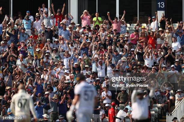 Fans celebrate as Joe Root of England hits a Six during Day One of the LV= Insurance Ashes 1st Test match between England and Australia at Edgbaston...