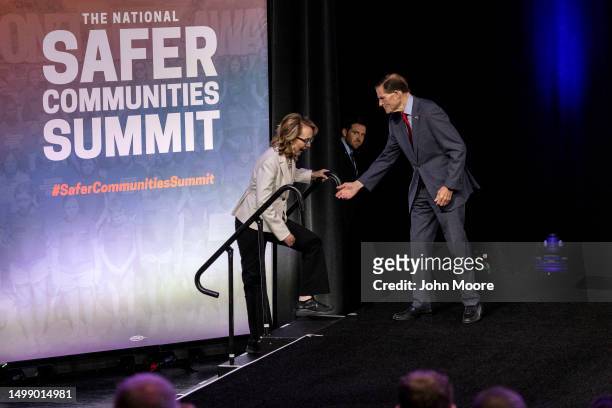 Gun control advocate and former U.S. Rep. Gabby Giffords takes the stage as Sen. Richard Blumenthal offers assistance during the National Safer...