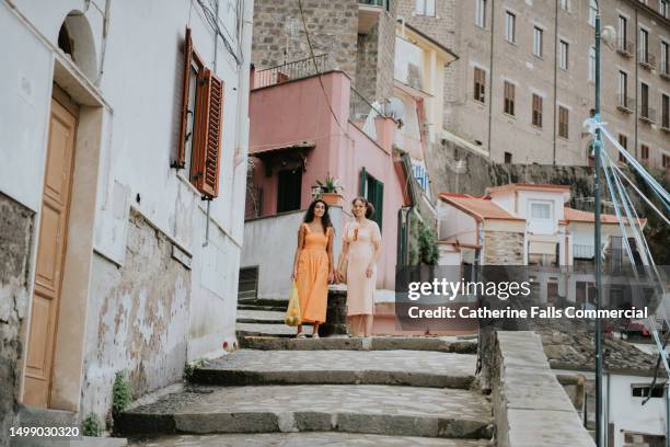 two woman explore the streets of sorrento, italy, the descend a set of steps. - stone town stock pictures, royalty-free photos & images