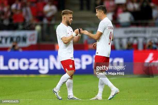 Jakub Blaszczykowski of Poland hands the captains armband to Robert Lewandowski of Poland after leaving the pitch during the international friendly...