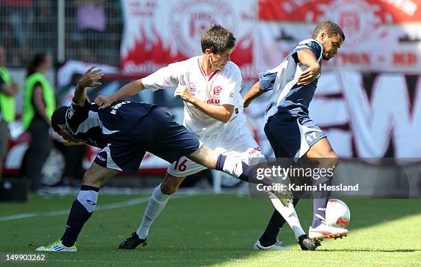 Dennis Mast of Halle challenges Kevin Moehwald and Phil Ofosu-Ayeh of Erfurt during the 3.Liga match between Hallescher FC and RW Erfurt at the...