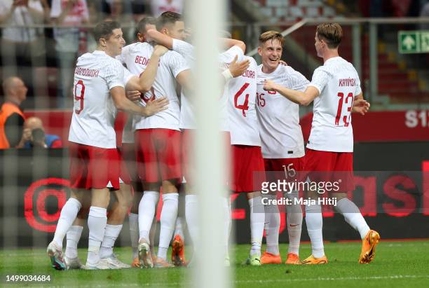 Jakub Kiwior of Poland celebrates with team mates after scoring their sides first goal during the international friendly match between Poland and...