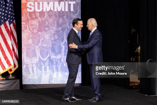 President Joe Biden is greeted by Sen. Chris Murphy before speaking at the National Safer Communities Summit at the University of Hartford on June...