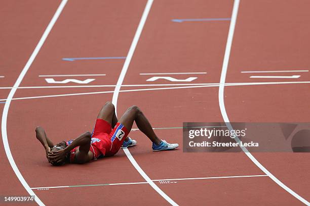 Moise Joseph of Haiti lays on the track after he competes in the Men's 800m heat on Day 10 of the London 2012 Olympic Games at the Olympic Stadium on...