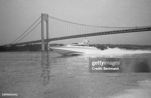 The speedboat Virgin Atlantic Challenger II powers past the Verrazano bridge as it heads for the Ambrose Light outside New York harbor. Skippered by...