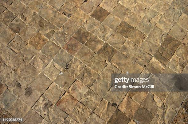 square-shaped beige light brown stone tiles on an outdoor patio - mexican rustic stock pictures, royalty-free photos & images