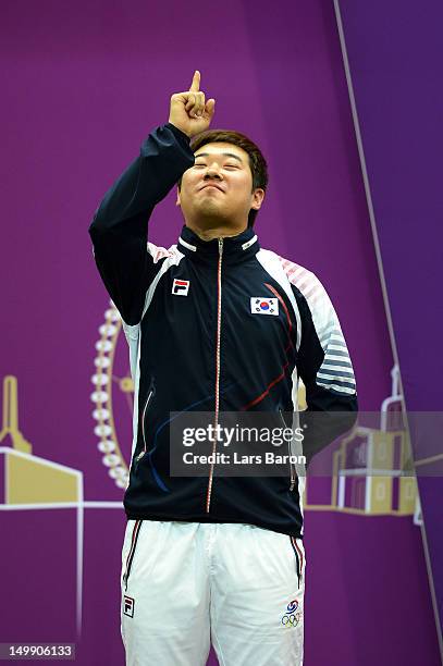 Silver medallist Jonghyun Kim of Korea celebrates during the medal ceremony for the Men's 50m Rifle 3 Positions Shooting Final on Day 10 of the...