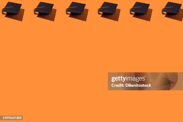 pattern of black graduation caps with gold tassel with hard shadow, on top, on orange background. graduation, achievement, goal, degree, master's, bachelor's, university, success concept. - draft first round stock pictures, royalty-free photos & images