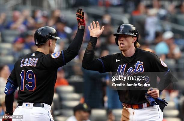 Brett Baty of the New York Mets is congratulated by Mark Canha after scoring during the 1st inning game against the St. Louis Cardinals at Citi Field...