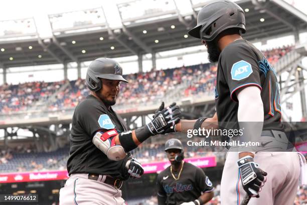 Luis Arraez of the Miami Marlins celebrates a two run home run with Bryan De La Cruz in the second innings during a baseball game against the...