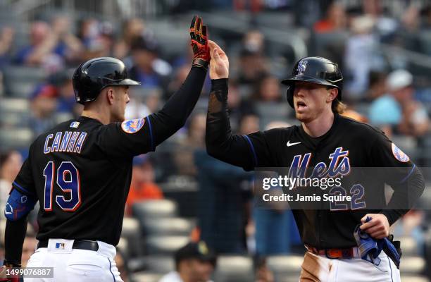 Brett Baty of the New York Mets is congratulated by Mark Canha after scoring during the 1st inning game against the St. Louis Cardinals at Citi Field...