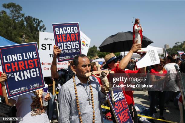 Protesters hold signs at a Catholics for Catholics event in response to the Dodgers' Pride Night event including the Sisters of Perpetual Indulgence,...