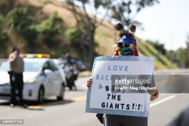 Counter-protester holds a sign outside a Catholics for Catholics event in response to the Dodgers' Pride Night event including the Sisters of...