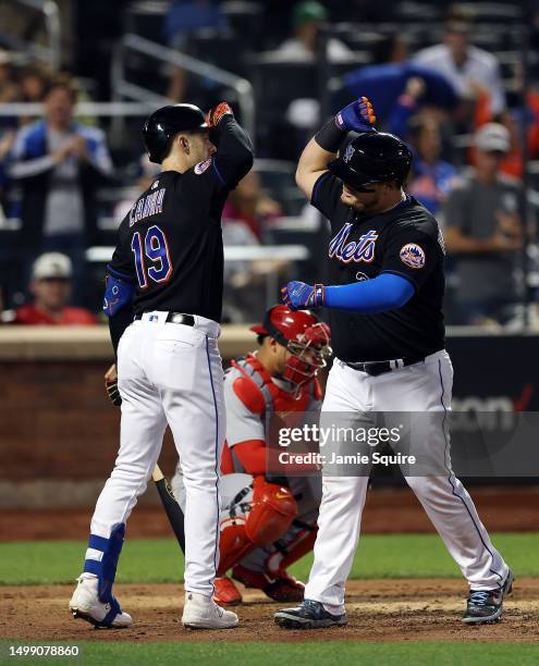 Daniel Vogelbach of the New York Mets is congratulated by Mark Canha after hitting a home run during the 6th inning of the game against the St. Louis...
