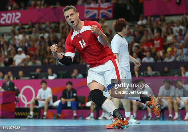 Michael Knudsen of Denmark celebrates a point during the Men's Handball preliminaries group B match between Denmark and Korea on Day 10 of the London...