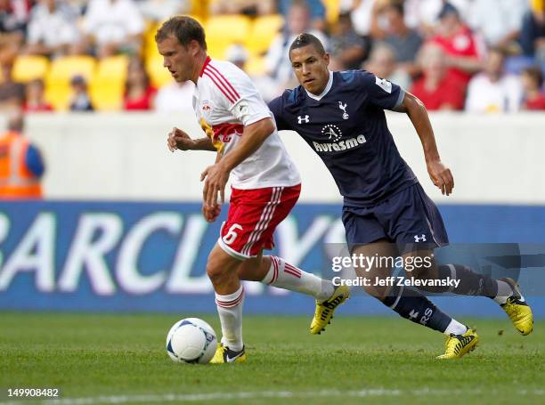 Teemu Tainio of New York Red Bulls drives in front of Jake Livermore of Tottenham Hotspur during their match at Red Bull Arena on July 31, 2012 in...