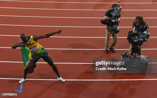 Usain Bolt of Jamaica celebrates after his win gold in the Men's 100m Final on Day 9 of the London 2012 Olympic Games at the Olympic Stadiumat...