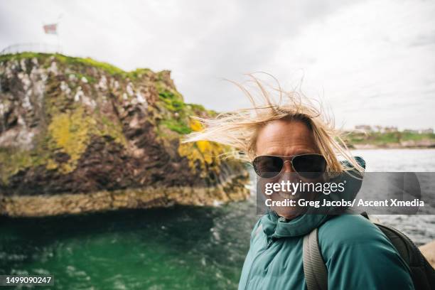 portrait of woman hiking above sea - women stock pictures, royalty-free photos & images