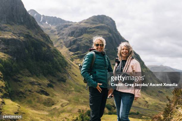 portrait of friends hiking mountain meadows - pink pants stock pictures, royalty-free photos & images