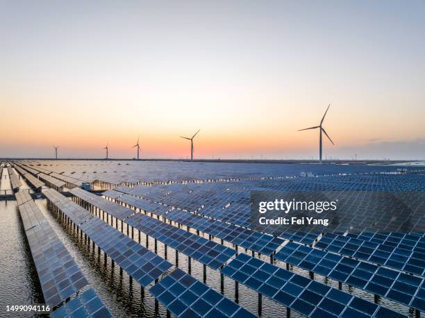 solar panels and wind power at dusk - wind solar energy stock pictures, royalty-free photos & images