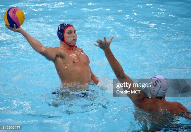 The USA's Jesse Smith lines up a shot over the outstretched arm of Hungary's Tamas Kasas in the second half of a Group B match at the Water Polo...