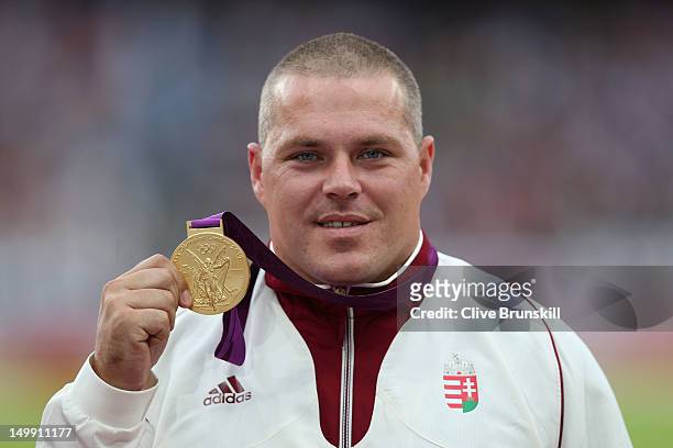 Gold medalist Krisztian Pars of Hungary poses on the podium during the medal ceremony for the Men's Hammer Throw final on Day 10 of the London 2012...