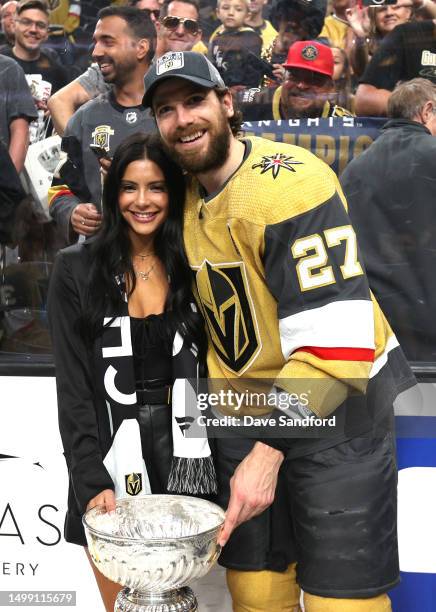 Shea Theodore of the Vegas Golden Knights poses for a photo with the Stanley Cup after Game Five of the 2023 NHL Stanley Cup Final between the...