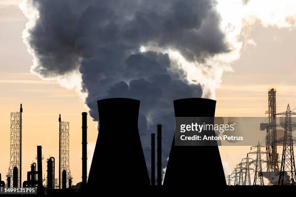 explosion at a nuclear power plant. smoke over the station - burst pipes stockfoto's en -beelden