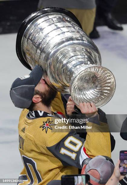 Nicolas Roy of the Vegas Golden Knights hoists the Stanley Cup after the team's 9-3 victory over the Florida Panthers in Game Five of the 2023 NHL...