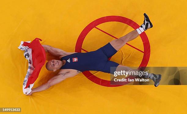 Damian Janikowski of Poland celebrates beating Melonin Noumonvi of France in their Men's Greco-Roman 84 kg Bronze Medal bout on Day 10 of the London...