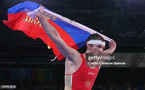 Alan Khugaev of Russia celebrates beating Karam Mohamed Gaber Ebrahim of Egypt in their Men's Greco-Roman 84 kg Gold Medal bout on Day 10 of the...