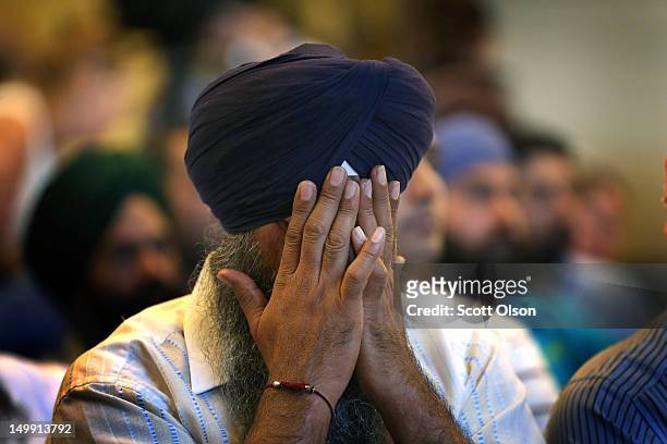 Member of the Miwaukee area Sikh community weeps as he listens to information about the shooting spree of Wade Michael Page August 6, 2012 in Oak...