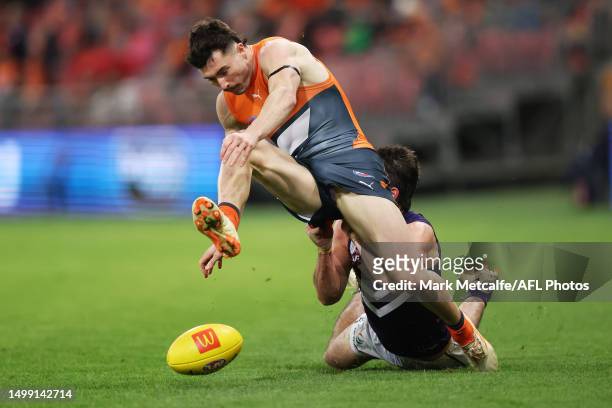 Lachie Ash of the Giants is tackled by Andrew Brayshaw of the Dockers during the round 14 AFL match between Greater Western Sydney Giants and...