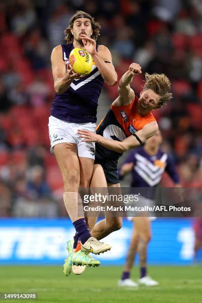 Luke Jackson of the Dockers and Lachie Whitfield of the Giants compete for the ball during the round 14 AFL match between Greater Western Sydney...
