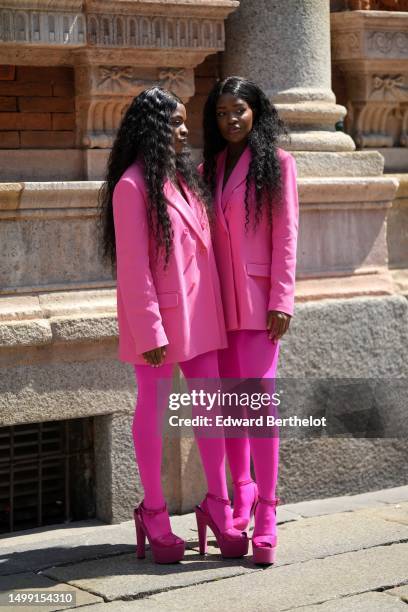 Guest wears a neon pink oversized blazer jacket from Valentino, neon pink tights, neon pink shiny varnished leather heels platform soles shoes ,...
