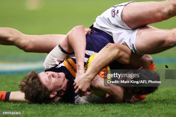 Nathan O'Driscoll of the Dockers is tackled by Stephen Coniglio of the Giants during the round 14 AFL match between Greater Western Sydney Giants and...